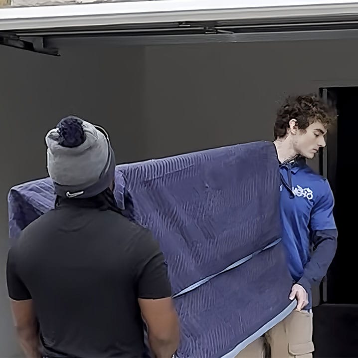 a man standing next to a window