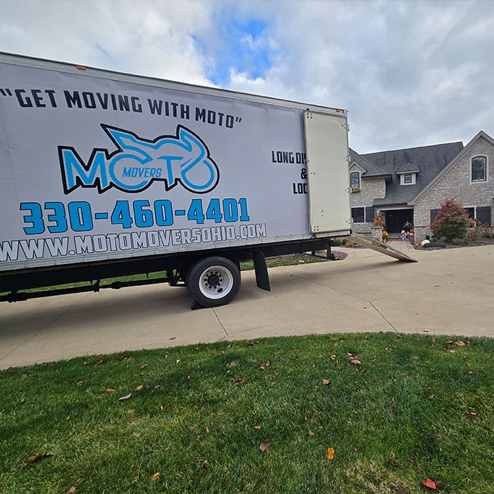 a truck that has a sign on the side of a road