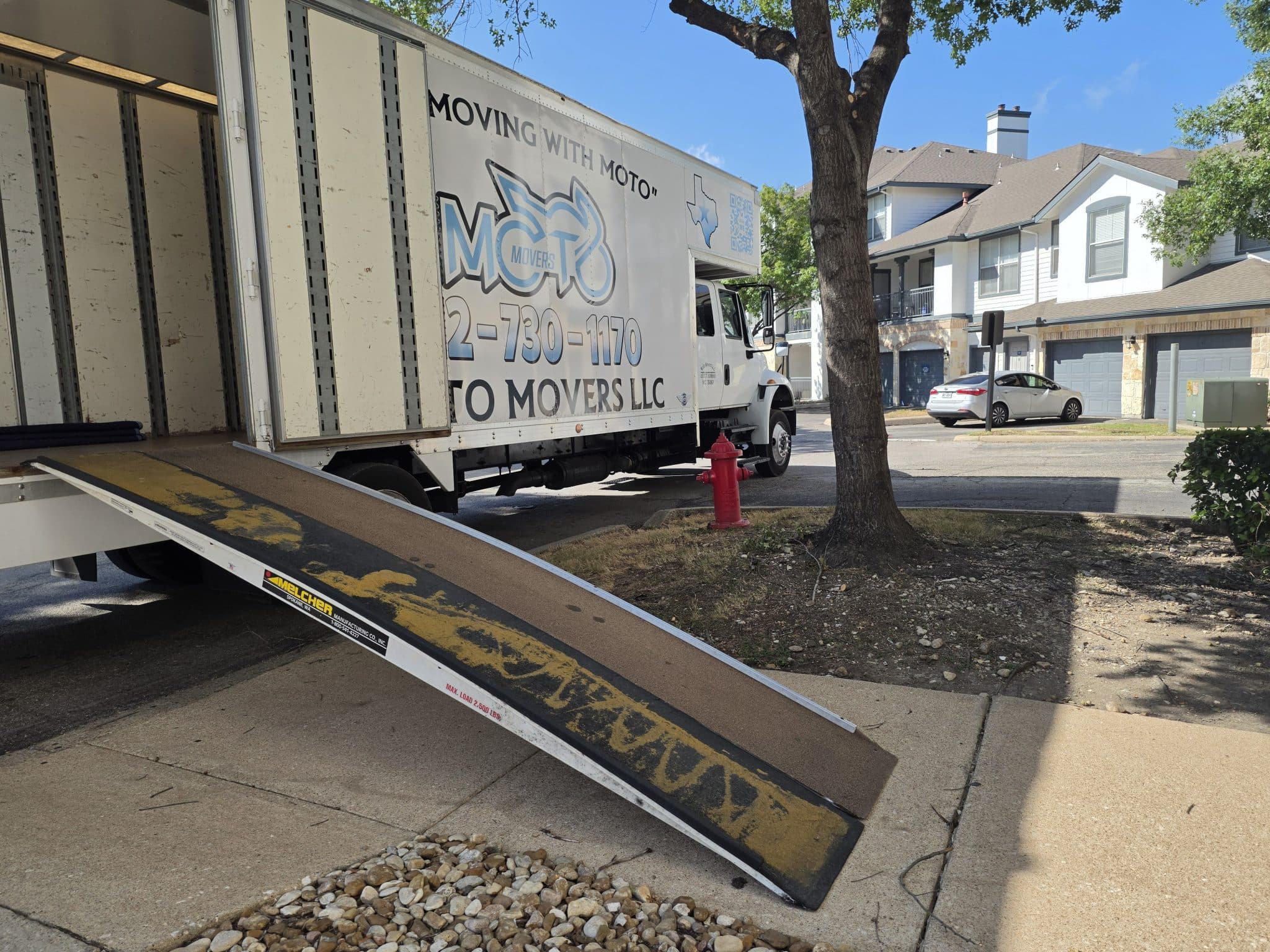 Moto Movers truck and ramp set up for loading at Presidio Apartment Homes in Austin, Texas.